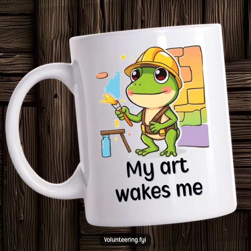 Funny mug featuring a diligent green frog in a hard hat carefully painting a colorful mural section, symbolizing creative construction.