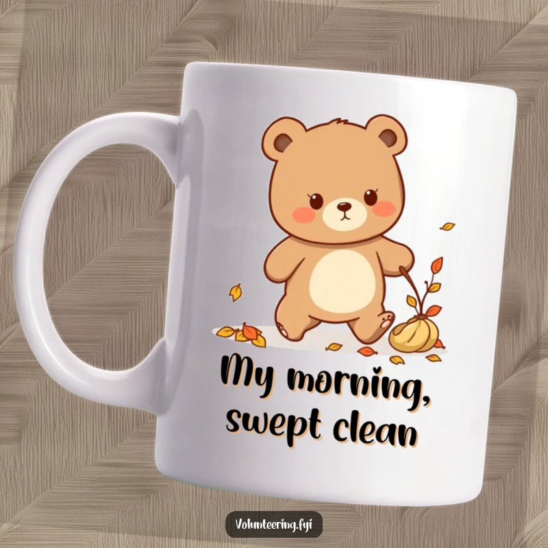 Funny Kawaii bear determinedly walking with fallen leaves to tidy up a path, cute autumn mug.