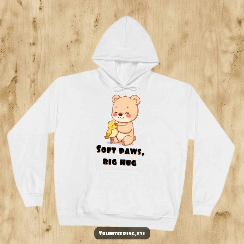 Funny hoodie depicting a happy bear cub softly patting a small, bewildered bird, highlighting gentle companionship.