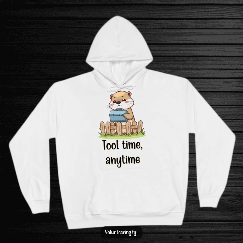 Funny hoodie featuring a helpful otter passing a toolbox over a fence, embodying a spirit of assistance.