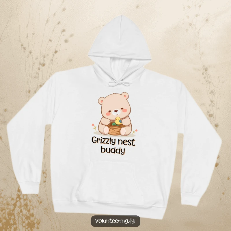 Funny, cozy hoodie showing a large bear assisting a small bird with nest construction, symbolizing gentle strength and camaraderie.
