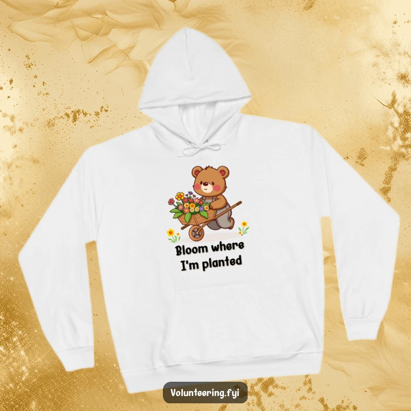 Funny Hoodie: Determined brown bear in overalls enthusiastically pushes a wheelbarrow filled with colorful flowers, cozy and cheerful.