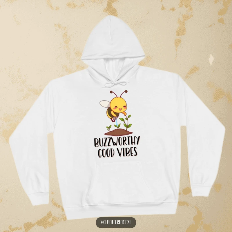 Funny hoodie print of a smiling bee diligently watering a small, wilting plant, a symbol of hope.