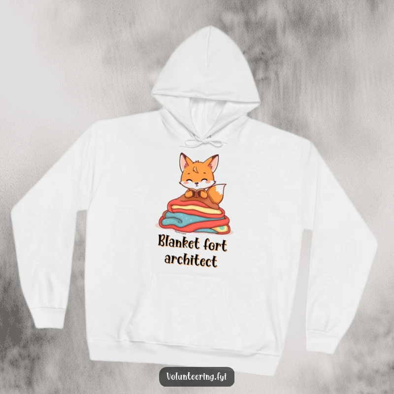 Funny Hoodie featuring a playful fox character organizing a pile of colorful blankets, symbolizing warmth, comfort, and neatness.