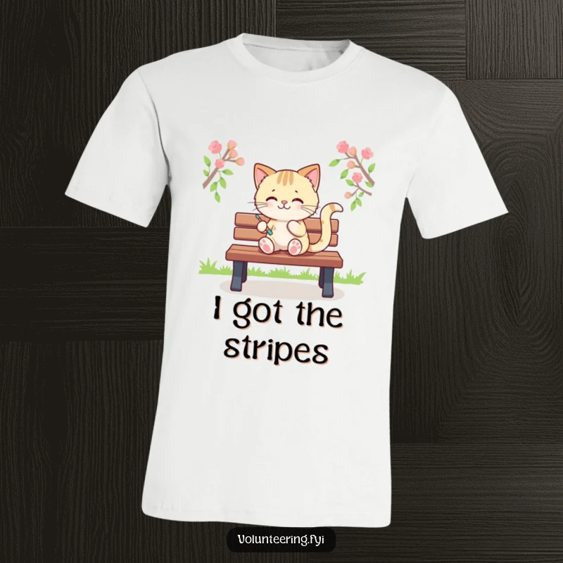 Funny t-shirt featuring a playful Kawaii cat painting colorful stripes on a park bench, showcasing artistic talent, a wonderful funny gift.