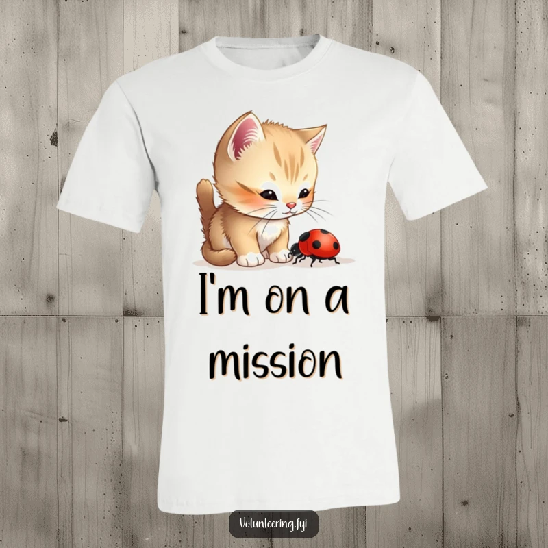 Funny Kitten Ladybug T-Shirt showing a curious kitten helping a lost ladybug find its way, embodying gentle kindness and adorable teamwork.