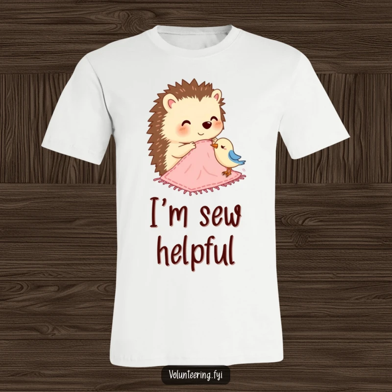 Funny t-shirt with a cheerful hedgehog sewing a small blanket for a bird, showcasing compassion and creativity.