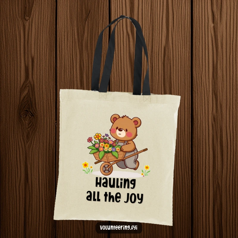 Funny Tote Bag: Determined brown bear in overalls enthusiastically pushes a wheelbarrow filled with colorful flowers, carrying joy.