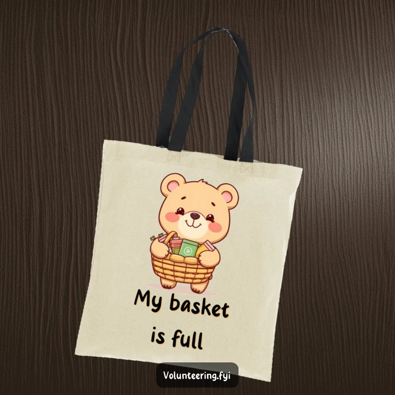 Funny tote bag with a grinning bear carrying a basket of donated items, ideal for carrying charity goods.